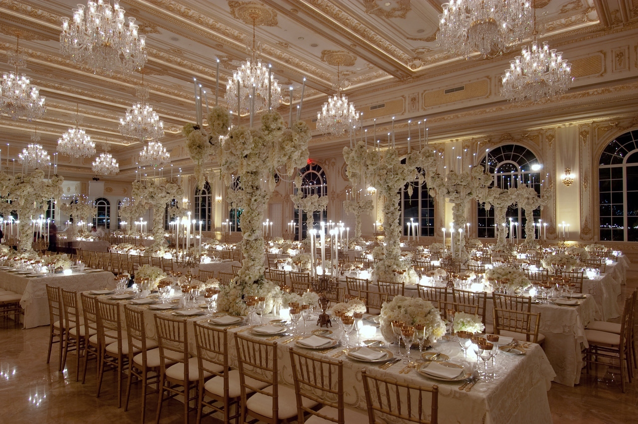 Elegant formal event architecture with floral installations and chandeliers